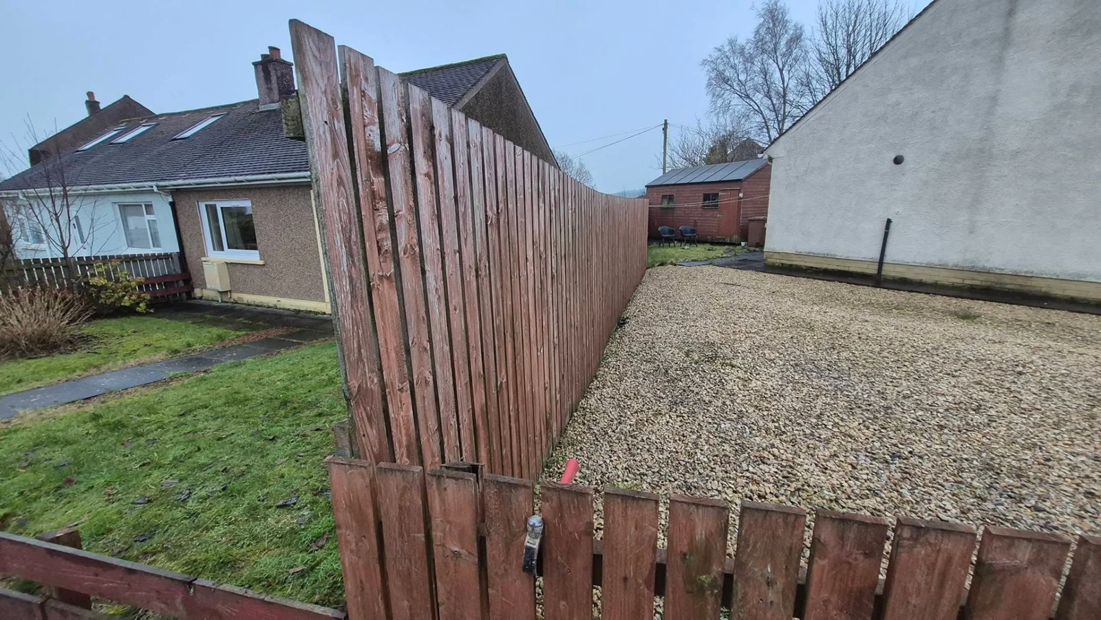 CM timber boundary fencing alongside a gravelled outdoor space
